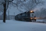 The beams of light from 6351 pierce the falling snow as Z127 slowly works its way south just after dawn